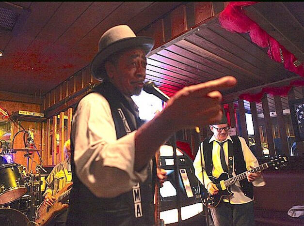 Oklahoma Ollie entertaining a live audience with blues music